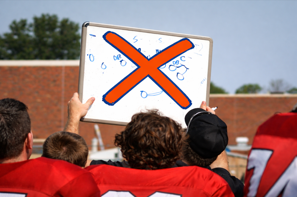 white board is crossed while a coach is showing it